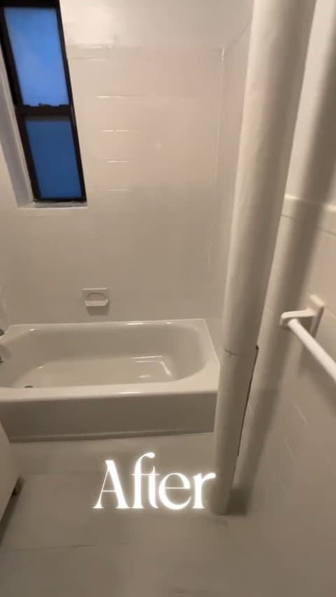 Bathroom with white bathtub and wall tile